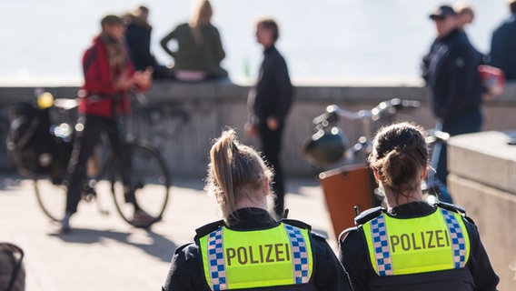 Zwei Polizistinnen kontrollieren am Zugang zum Elbstrand Övelgönne das in der Corona-Pandemie geltende Alkoholverbot. © picture alliance / dpa Foto: Daniel Bockwoldt