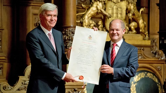 Hamburgs Bürgermeister Olaf Scholz (r.) überreicht im Rathaus dem Unternehmer Michael Otto die Urkunde für dessen Ehrenbürgerwürde. © dpa-Bildfunk Foto: Sven Hoppe