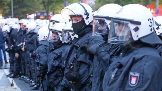 Polizisten mit Helmen begleiten eine Demonstration von G20-Gipfel-Gegnern. © picture-alliance/dpa Foto: Bodo Marks