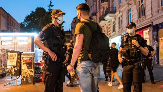 Die Polizei kontrolliert eine Person. © picture alliance/dpa Foto: Daniel Bockwoldt