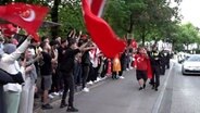 Zahlreiche Menschen feiern in Hamburg den Ausgang der Wahlen in der Türkei. Einige halten eine große türkische Fahne. © Nonstop News Foto: Screenshot