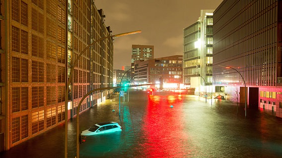Ein Auto schwimmt in der von einer Sturmflut überschwemmten Hafencity in Hamburg. © dpa Foto: Christian Charisius
