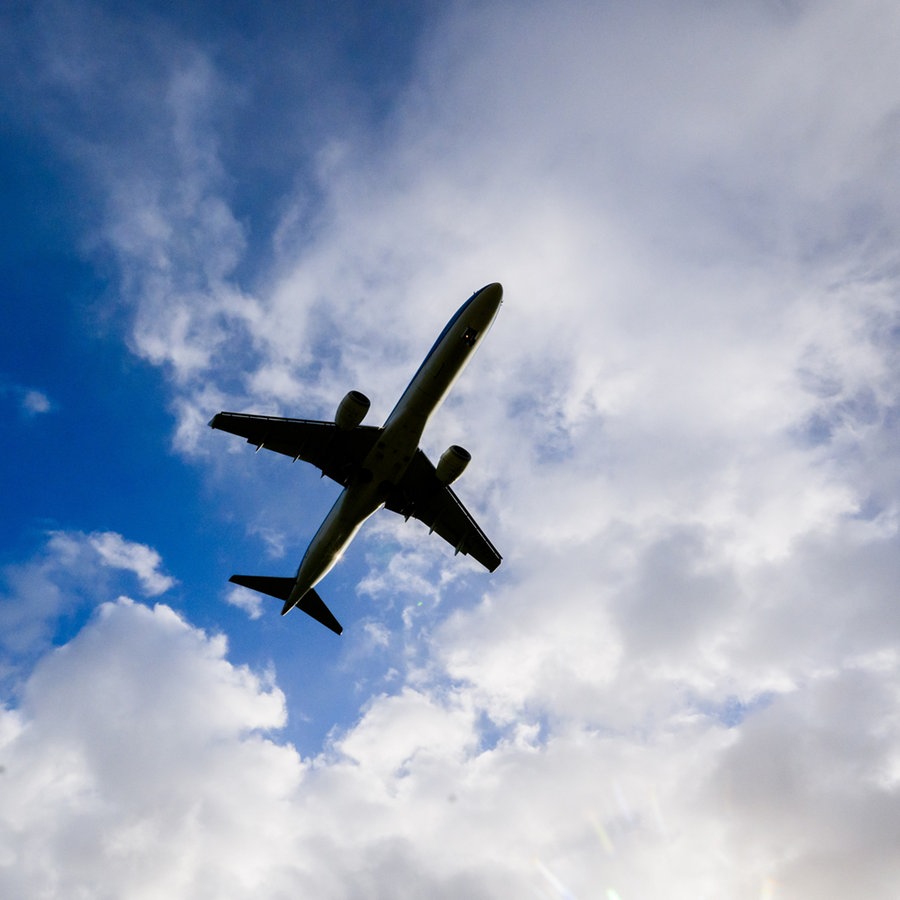 Ein Flugzeug fliegt am bewölkten Himmel © picture alliance/dpa Foto:  Julian Stratenschulte