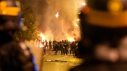 Polizeikräfte stehen Jugendlichen während Ausschreitungen in Nanterre, außerhalb von Paris, gegenüber. © Christophe Ena/AP/dpa 