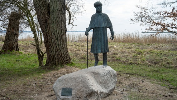 Eine Bronzestatue des Bildhauers Thomas Jastram auf einem Findling auf der Insel Rügen zeigt den Künstler Caspar David Friedrich. © dpa picture alliance Foto: Stefan Sauer