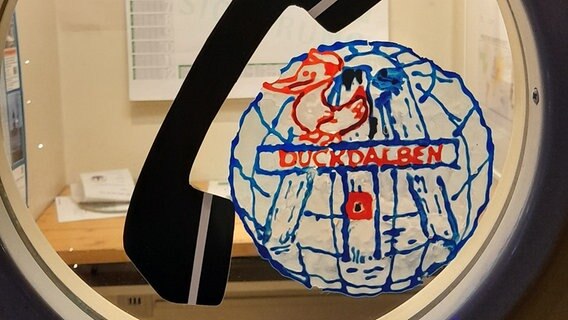 Eine der Telefonzellen im Duckdalben mit handgemachtem Logo. © NDR Foto: Aniela von Porthan