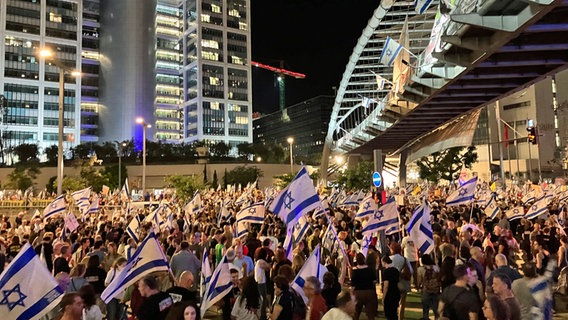 Menschen demonstrieren im Zentrum von Tel Aviv in der Derech Menachem Begin Street. Der Protest richtet sich gegen die israelische Regierung und für einen Geisel-Abkommen mit der Hamas. © Cindy Riechau/dpa 
