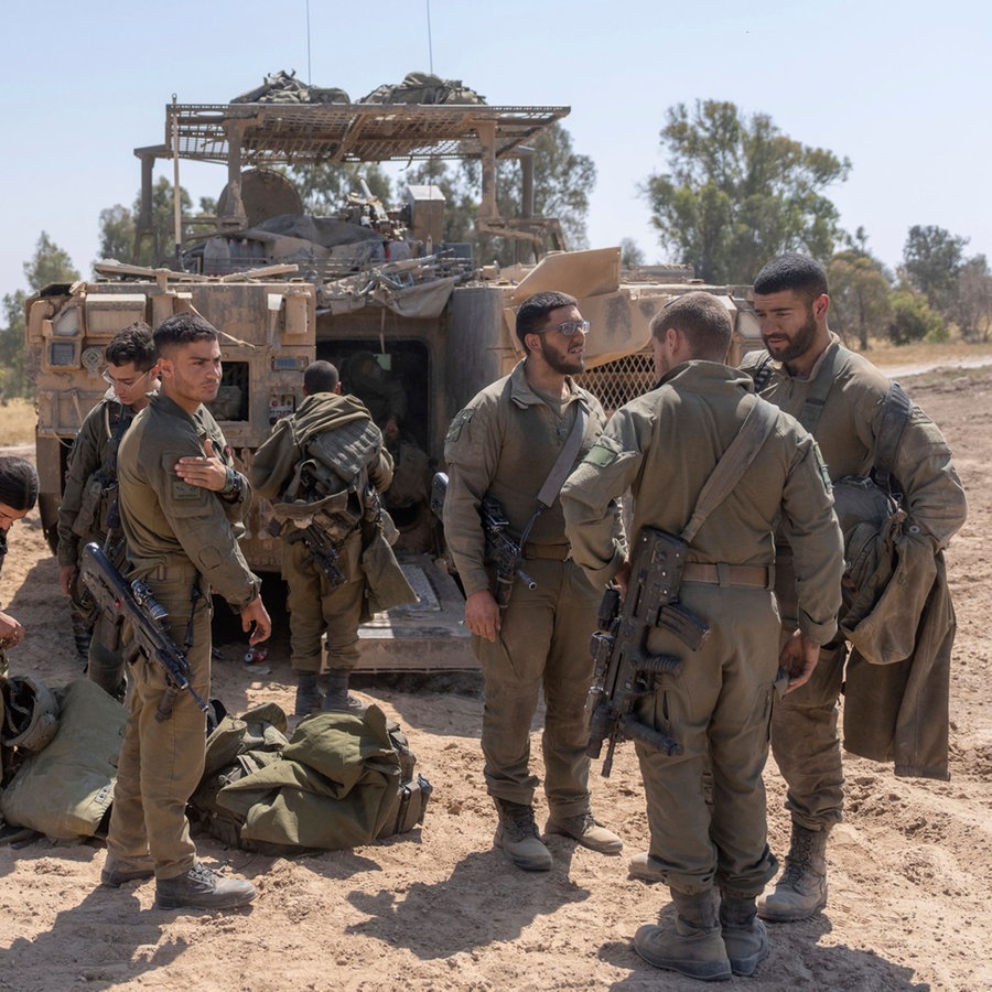 Israelische Soldaten stehen neben Mannschaftstransportern in der Nähe der Grenze zwischen Israel und Gaza. © AP/dpa Foto: Ohad Zwigenberg