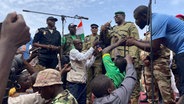Niger, Niamey: Mohamed Toumba, einer der Soldaten, die den nigrischen Präsidenten Mohamed Bazoum gestürzt haben, spricht zu Anhängern der nigrischen Junta. © AP/dpa Foto: Sam Mednick