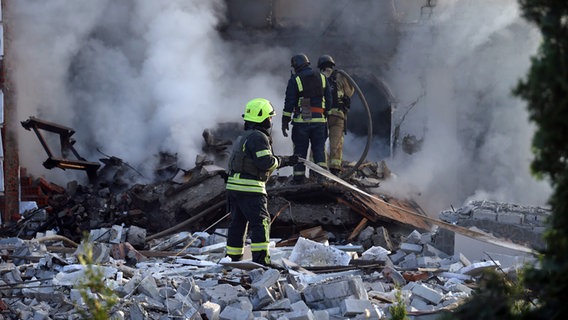 Nach einem russischen Raketenangriff löschen Rettungskräfte das Feuer auf ein Haus in der ukrainischen Stadt Charkiw. © Ukrinform/dpa Foto: not credited