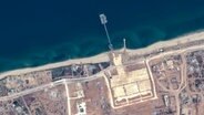 Dieses von Maxar Technologies via AP veröffentlichte Satellitenfoto zeigt den neuen Pier vor Gaza und Hilfsgütertransporter. © Uncredited/Maxar Technologies/AP/dpa 