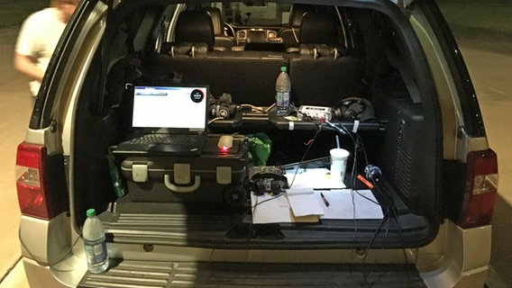 In einem Kofferraum stehen ein Laptop und verschiedene technische Geräte. © ARD Studio Washington 