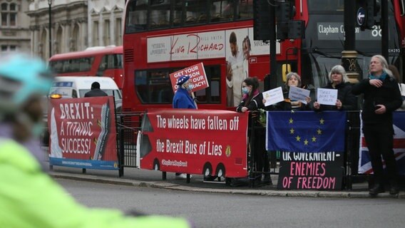 Plakate von Brexit-Gegnern vor einem roten Bus in Londons Innenstadt. © dpa picture alliance Foto: Hasan Esen