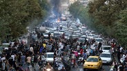 Demonstranten während eines Protestes in der Innenstadt von Teheran gegen den Tod der 22-jährigen Iranerin Mahsa Amini. (Aufnahme vom September 2022) © Uncredited/AP/dpa 