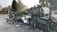 Ein ausgebrannter Bus auf einer Straße in Nordirland. © dpa picture alliance Foto: David Young