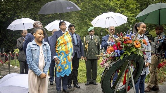 Der surinamische Präsident legt im Kreise anderer einen Kranz nieder. © dpa picture alliance Foto: Ramon van Flyman