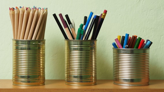 Stifte stehen in alten Konservendosen © IMAGO / agefotostock 