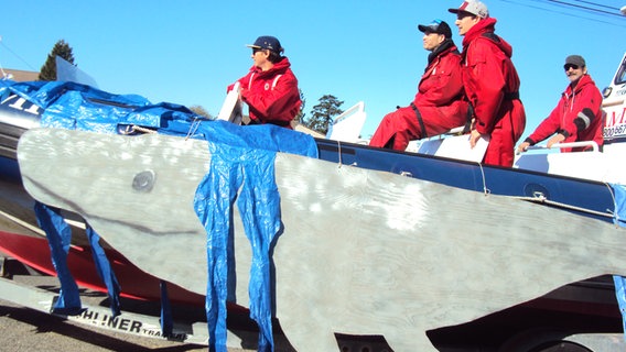 Ein Team in roten Anzügen auf einem Schnellboot, das Wale in Vancouver (Pacific Rim) beobachten will © NDR Foto: Guido Meyer