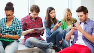 Junge Leute schauen auf ihre Smartphones © Fotolia.com Foto: Syda Productions