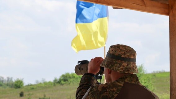 Soldat der Nationalgarde der Ukraine blickt durch ein Fernglas © Ukrinform/dpa 