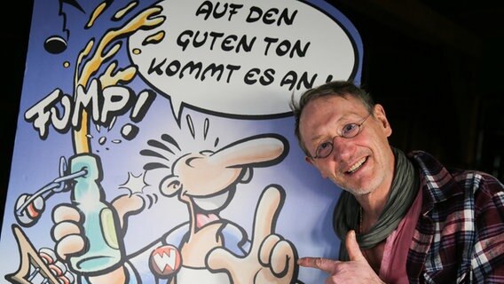 Der Comiczeichner Rötger Feldmann steht vor einer Zeichnung seiner Comicfigur Werner. © dpa-Bildfunk Foto: Axel Heimken
