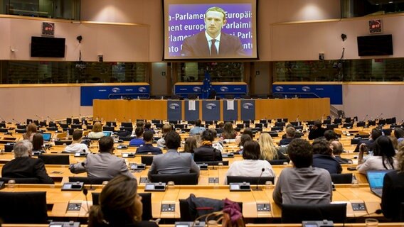 Facebook-Chef Mark Zuckerberg während einer Anhörung im EU-Parlament, übertragen auf einer großen Leinwand. © dpa Bildfunk Foto: Wiktor Dabkowski