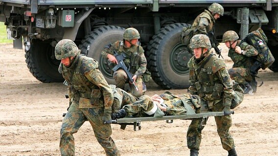 Bei einer Übung der Panzergrenadierbrigade 41 in Torgelow (Uecker-Randow-Kreis) bergen Soldaten die Verletzten nach einem simulierten Überfall von Angreifern auf einen Transportkonvoi. © picture-alliance Foto: Bernd Wüstneck