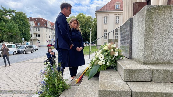 Bettina Martin und Burkhard Bley stehen in Schwerin vor einer Gedenktafel zum DDR-Volksaufstand vom 17. Juni 1953. © NDR 