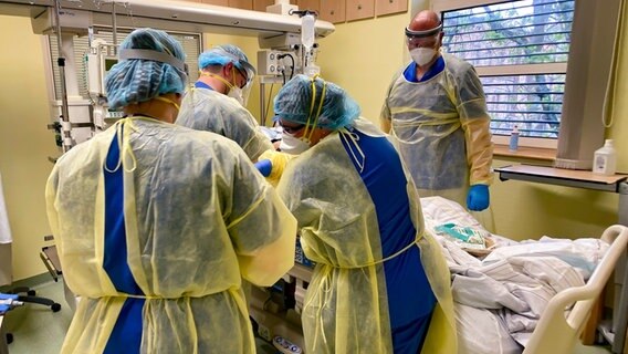 Vier Intensiv-Pfleger stehen rund um ein Krankenbett auf der Covid-19-Station im AMEOS Klinikum Ueckermünde. © NDR 