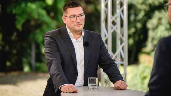 Der CDU-Politiker Franz-Robert Liskow steht an einem Tisch während eines Interviews. © NDR Foto: Katharina Kleinke