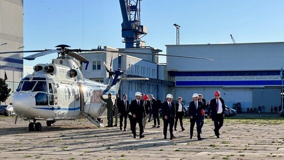 Bundesverteidigungsminister Boris Pistorius (M.) steigt aus einem Hubschrauber, der auf dem Gelände des Marinearsenals in Rostock gelandet ist © David Pilgrim Foto: David Pilgrim