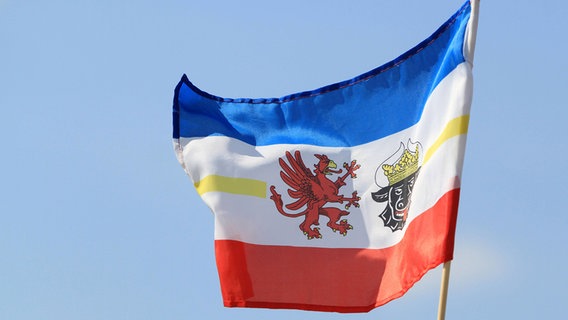 Die Flagge von Mecklenburg Vorpommern weht am Strand von Warnemünde. © imago Foto: imago/BildFunkMV