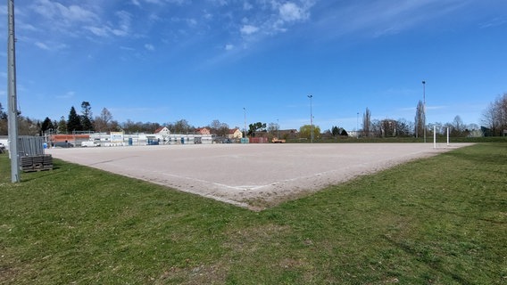 Der alte Schotter-Fußballplatz im Hansaviertel in Rostock. Im Hintergrund die Baustelle des neuen Vereinsgebäudes. © NDR Foto: Peter Göseke