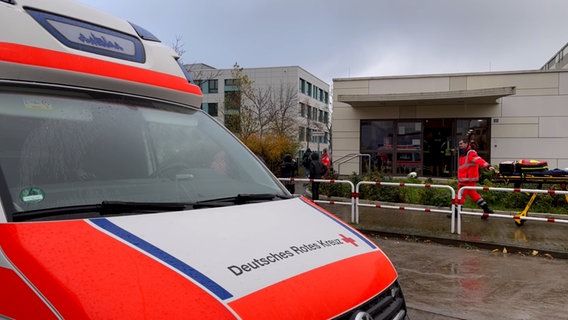 Rettungswagen und Rettungskräfte stehen vor einer Turnhalle in Neubrandenburg. © NDR MV/ Claudia Krüger Foto: NDR MV/ Claudia Krüger