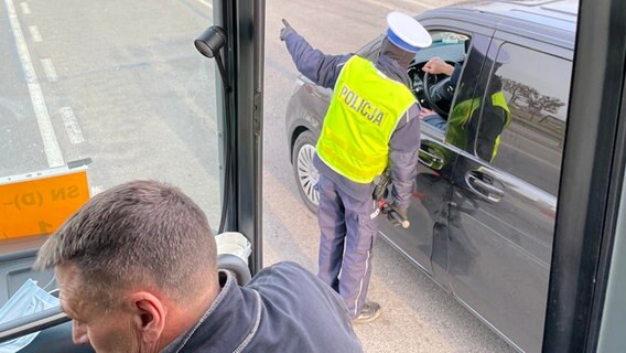Blick aus dem Bus auf polnischen Grenzbeamten  Foto: Christoph Kümmritz