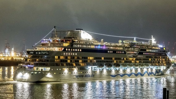 Ein Aida-Schiff bricht am Abend zu einer Kreuzfahrt auf. © dpa-Bildfunk Foto: Markus Scholz