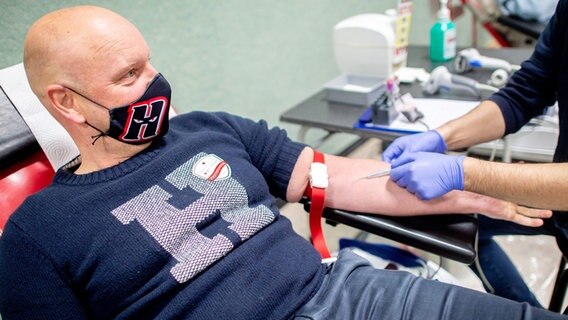 Ein Mann mit Maske spendet Blut. © dpa-Bildfunk Foto:  Hauke-Christian Dittrich