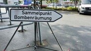 Ein weißes Schild mit dem Schriftzug "Sammelunterkunft Bombenentschärfung" © NDR Foto: Christiane von Possel