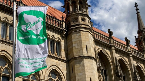 Eine Flagge mit der Aufschrift "Mayors for Peace" ist vor dem Braunschweiger Rathaus gehisst. © NDR Foto: Andreas Mier