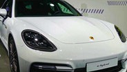 "E-hybrid" steht auf einem weißen Porsche. © NDR Foto: NDR