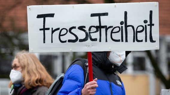 Ein Banner mit der Aufschrift "Fressefreiheit" (in Anlehnung an "Pressefreiheit") wird von einem Teilnehmer einer Demonstration gehalten. © picture alliance/dpa Foto: Friso Gentsch