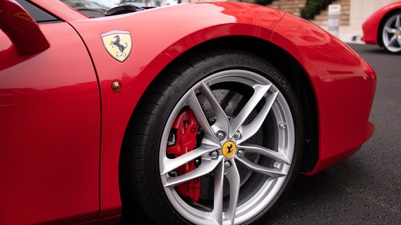 Ein roter Ferrari mit Logo. © picture alliance / abaca | Niviere David/ABACAPRESS.COM Foto: Niviere David