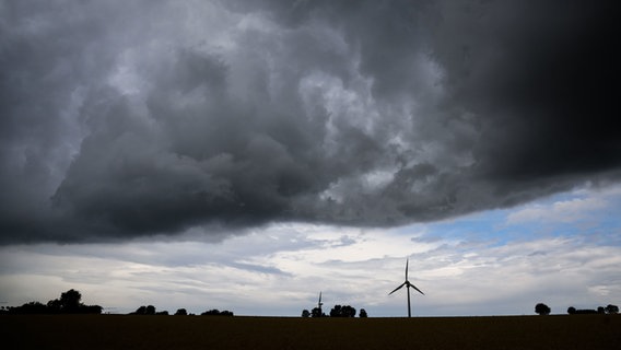 Eine Gewitterfront zieht über ein Windrad hinweg. © dpa-Bildfunk Foto: Julian Stratenschulte