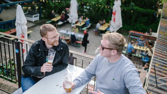 Zwei Männer sitzen in einem Biergarten in Hannover. © picture alliance/dpa Foto: Ole Spata