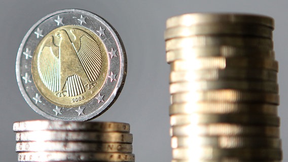 Ein Stapel mit Ein-Euro-Münzen steht neben einem Stapel mit Zwei-Euro-Münzen. © picture alliance/dpa Foto: Oliver Berg