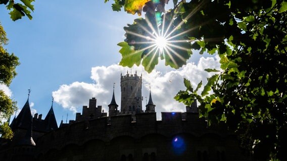 Die Sonne scheint durch herbstlich verfärbte Blätter am Schloss Marienburg in der Region Hannover. © dpa-Bildfunk Foto: Demy Becker