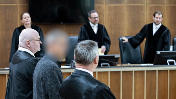 Der Angeklagte (2.v.l) steht vor Verhandlungsbeginn in einem Gerichtssaal im Landgericht Hannover. © dpa-Bildfunk Foto: Michael Matthey