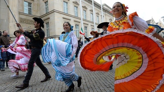 In mexikanischen Kostümen tanzen Teilnehmer des Schützenausmarsches durch die Innenstadt von Hannover. © dpa Foto: Peter Steffen