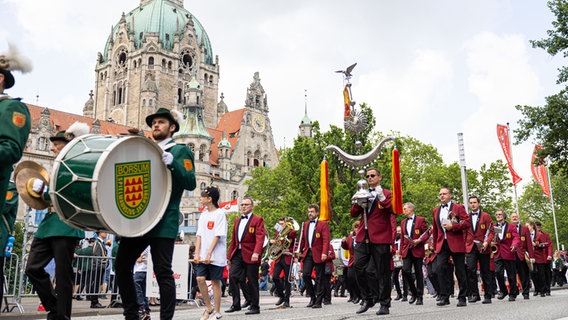 Teilnehmer vom Schützenausmarsch laufen vor dem Neuen Rathaus durch die Innenstadt von Hannover. © dpa-Bildfunk Foto: Michael Matthey
