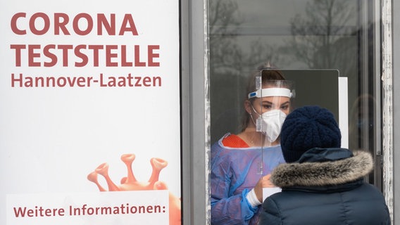 Eine Mitarbeiterin testet eine Patientin auf das Corona-Virus an der von einer Arztpraxis betriebenen Corona-Teststelle Hannover-Laatzen in der Region Hannover. © dpa Foto: Julian Stratenschulte